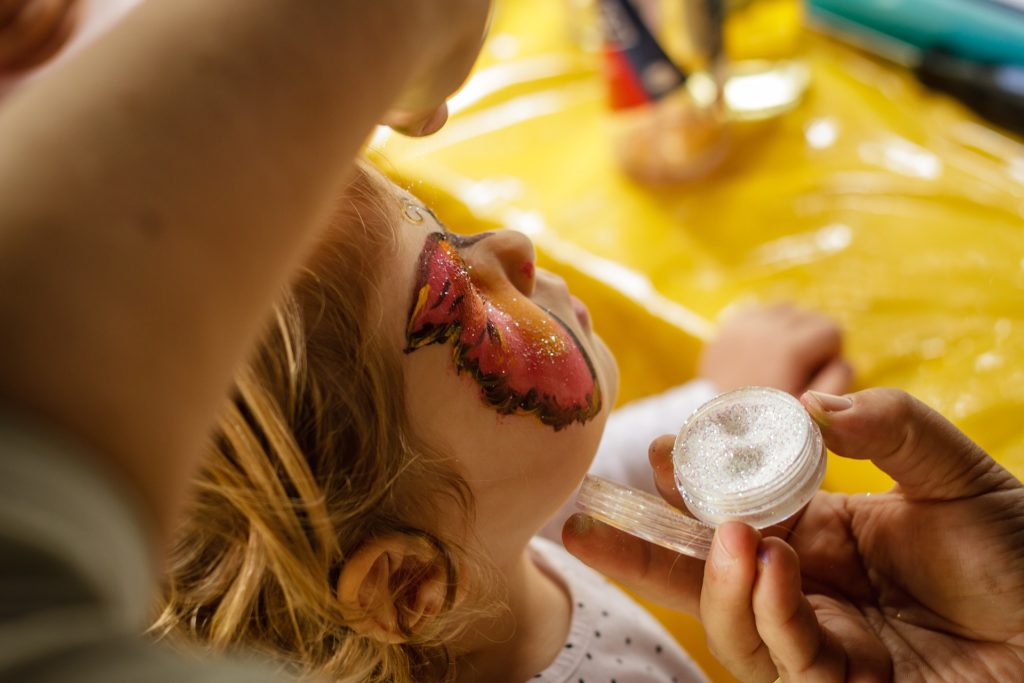 glitter on a child's face. another source for microplastic pollution